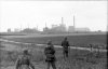 Bundesarchiv_Bild_101I-721-0353-27A,_Collombelles,_Soldaten_auf_Feld_vor_Fabrik.jpg